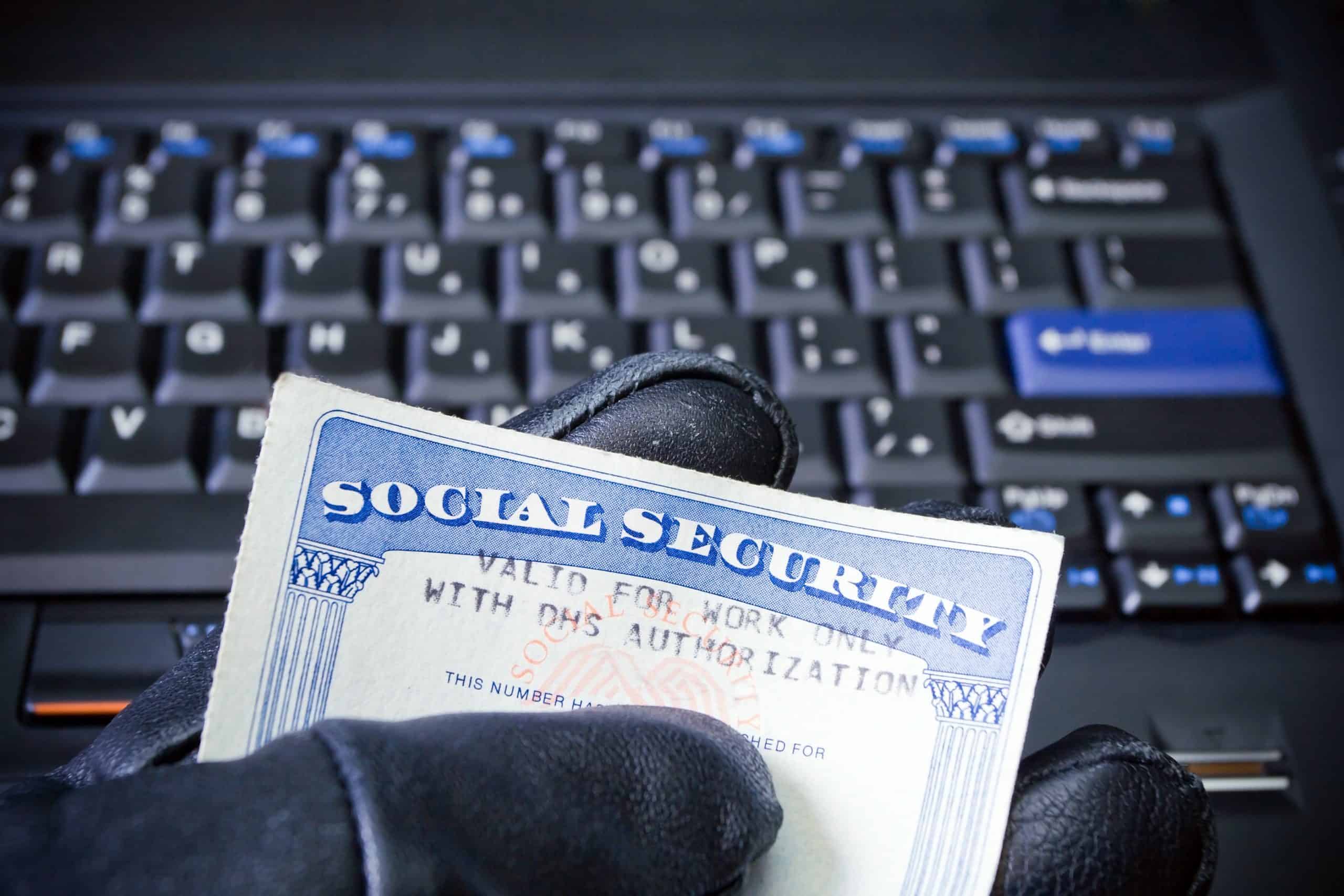 Social Security card in Computer,Hacker's hand internet and identity