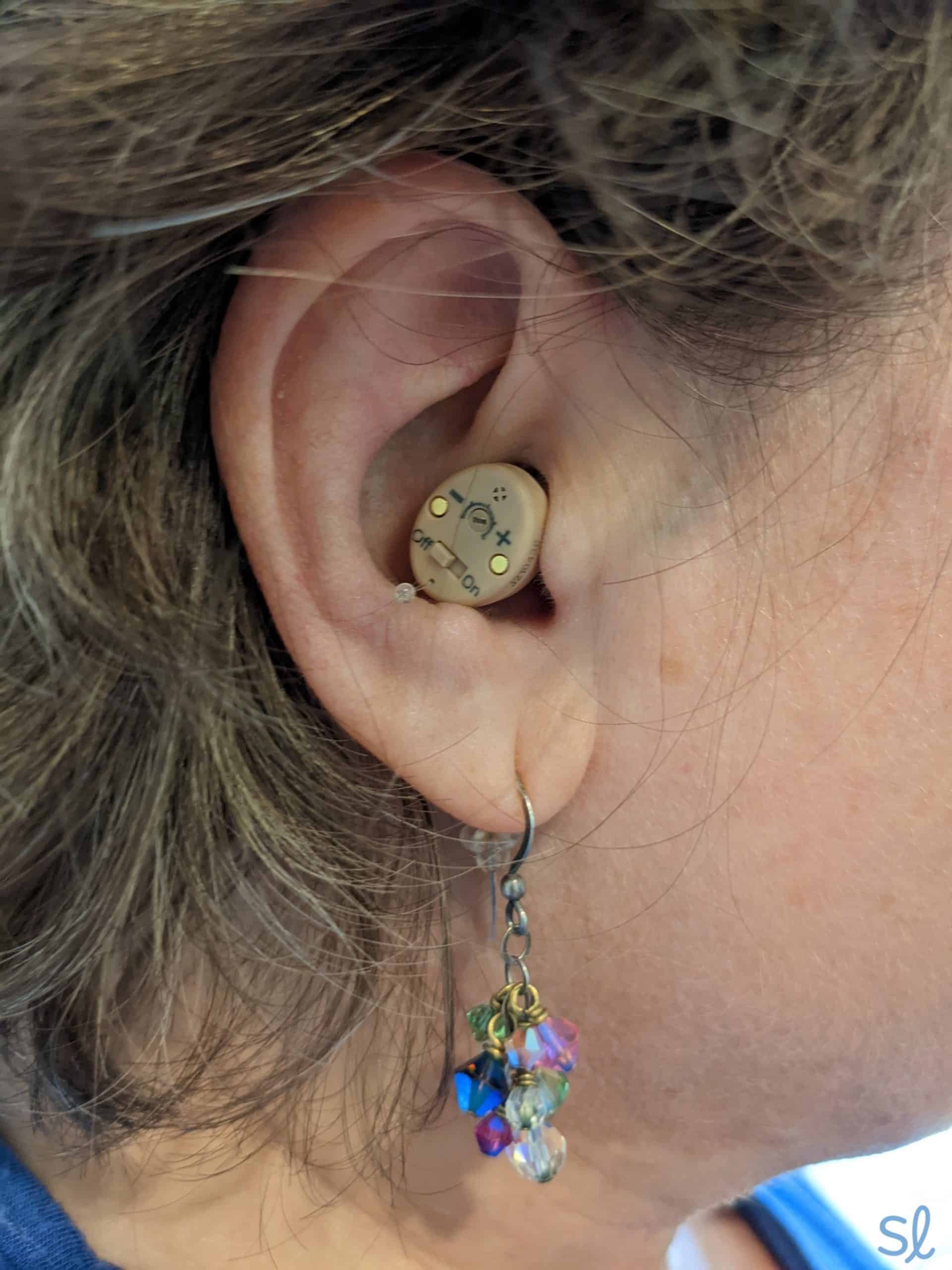 Person wearing Audien Atom hearing aids.
