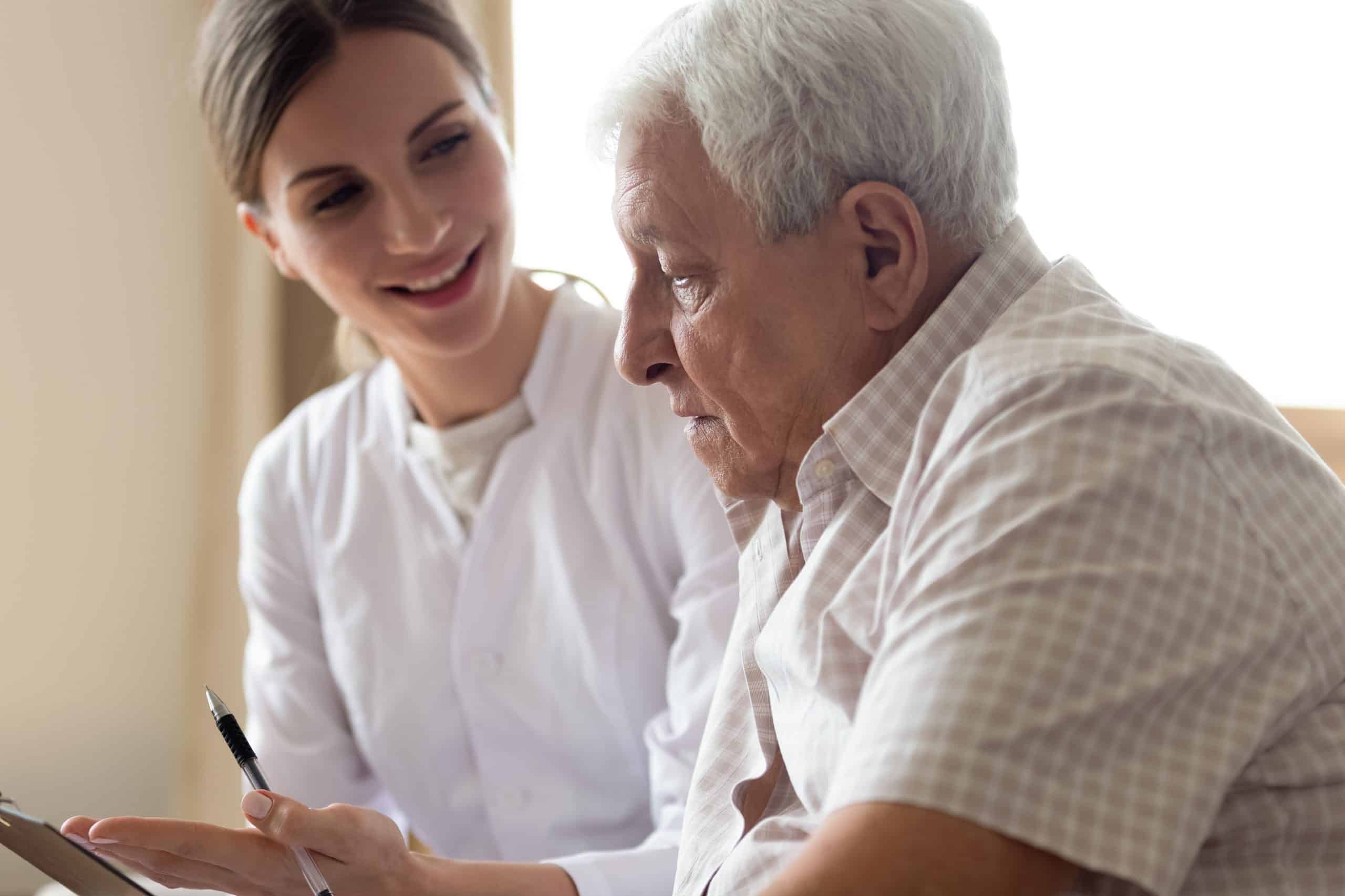 Senior man talking with female medical provider