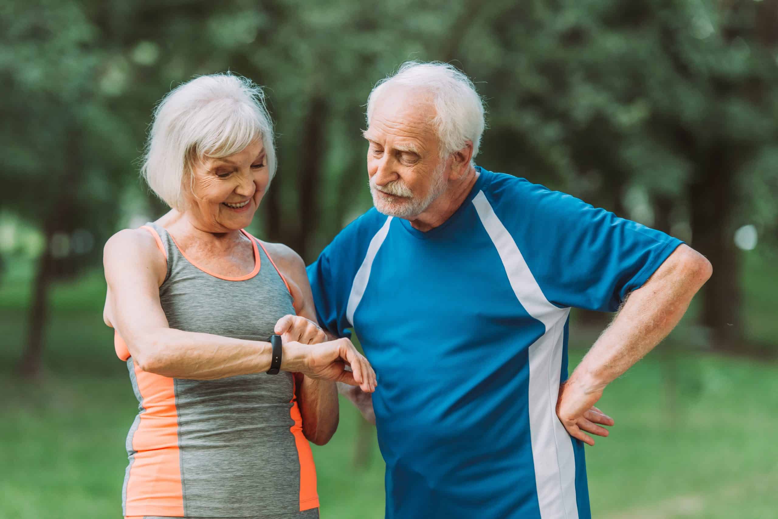 Senior woman and man checking a watch