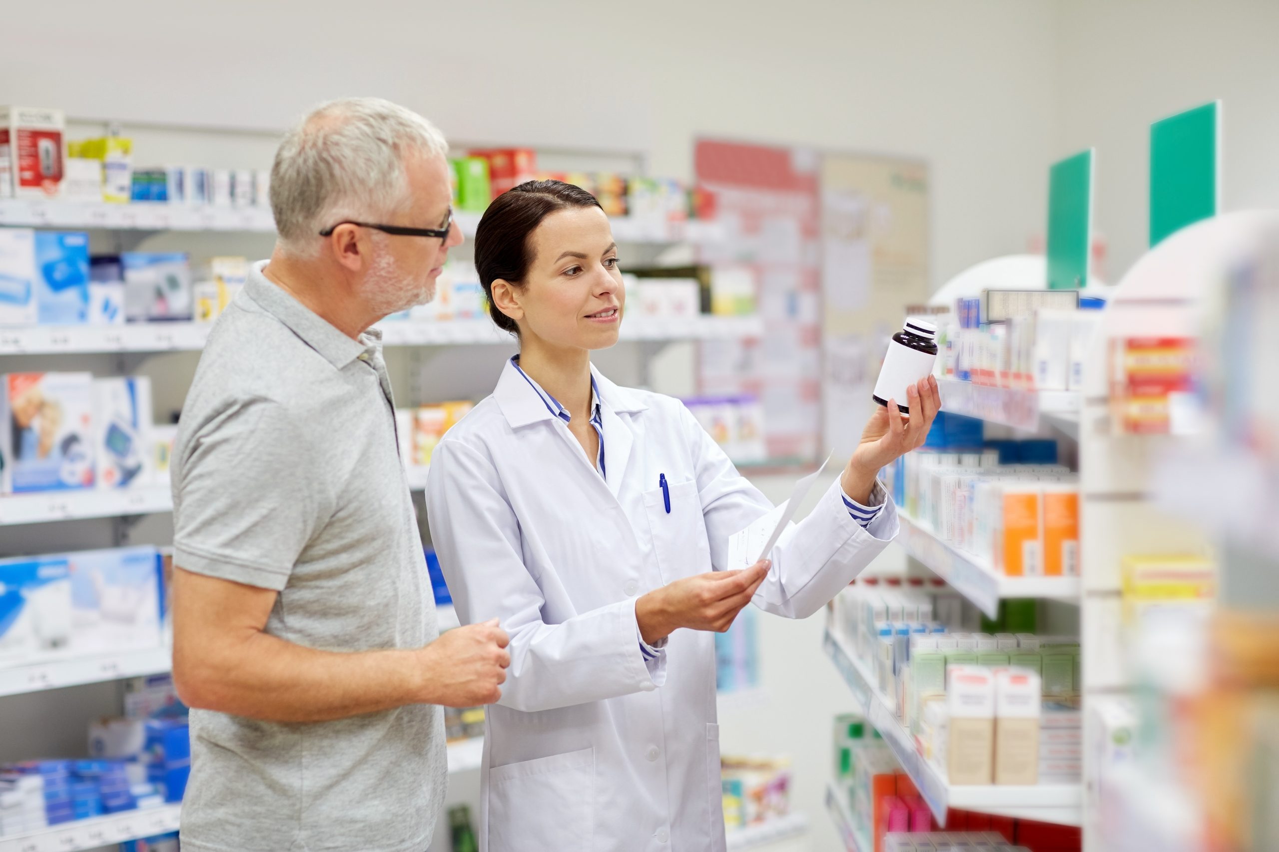 Pharmacist consulting a man on which medications to take