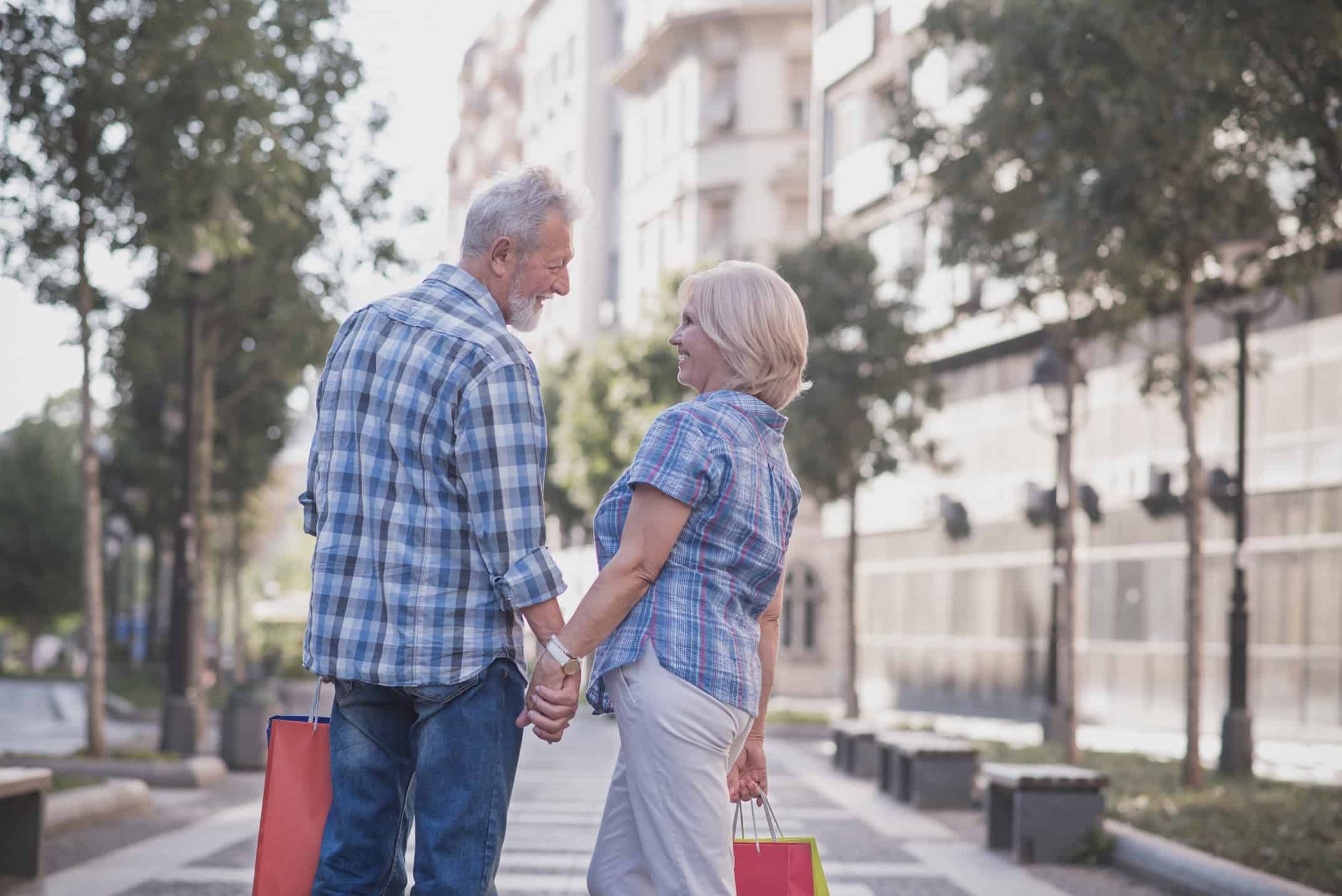 A couple holding hands on a street