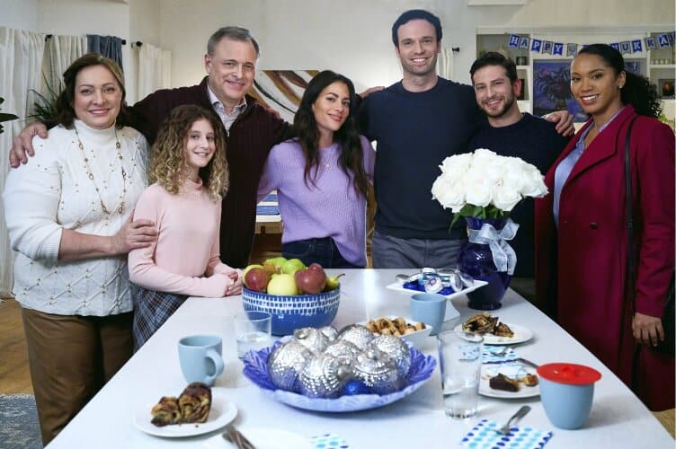 Image of a family around a holiday meal from the movie Eights Gifts of Hanukkah