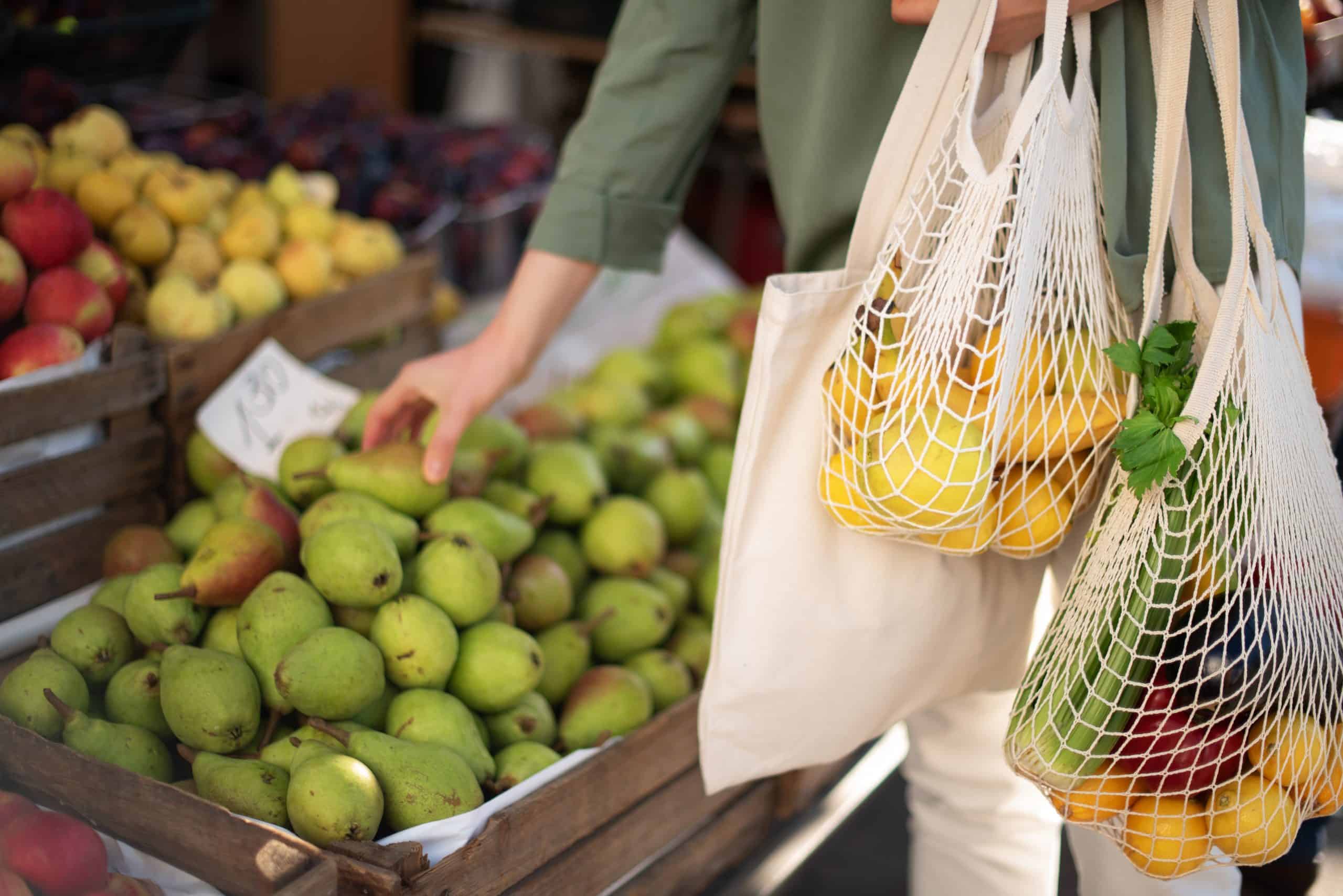 Woman using reusable bags for produce