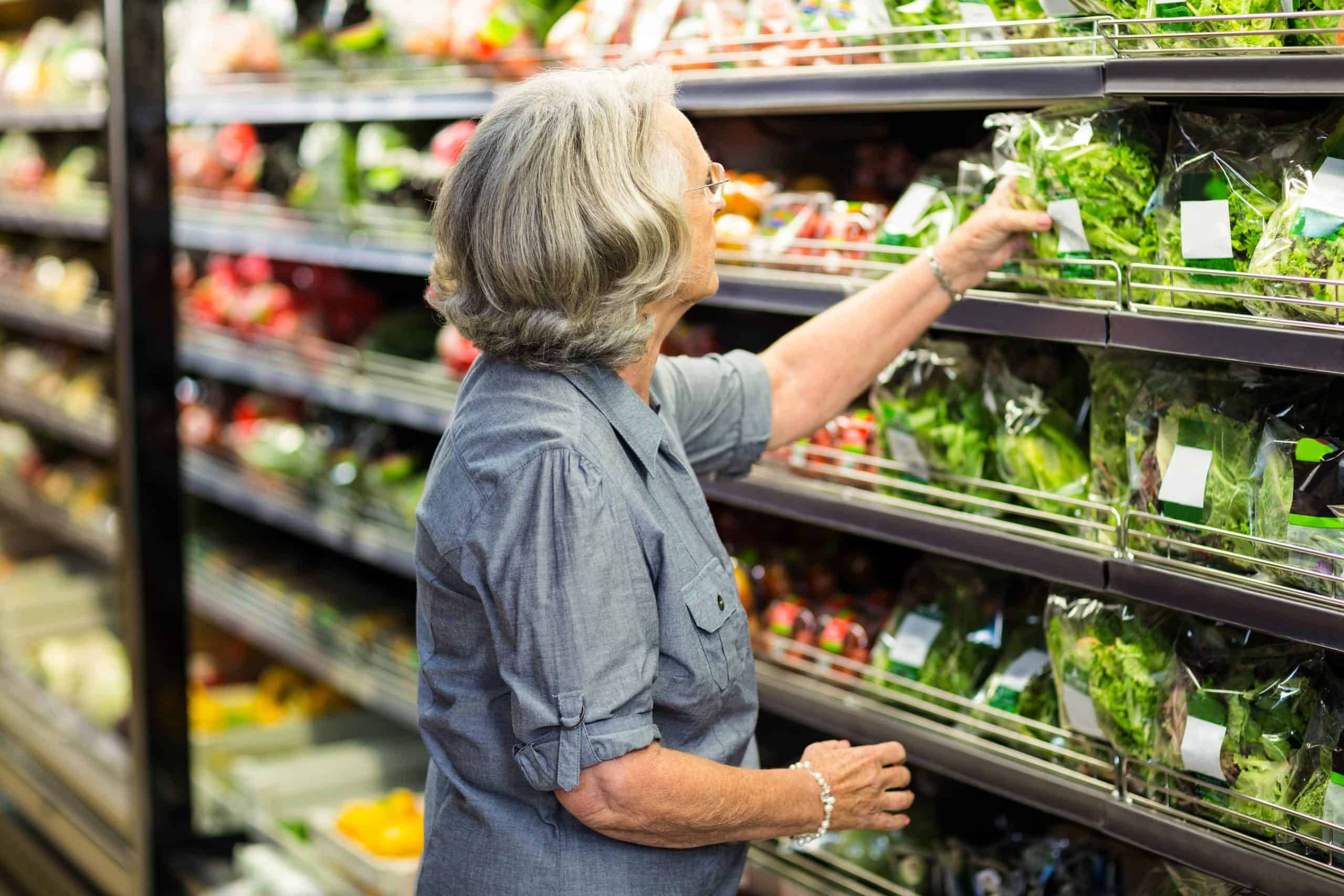 Woman shopping in the produce section at a grocery store