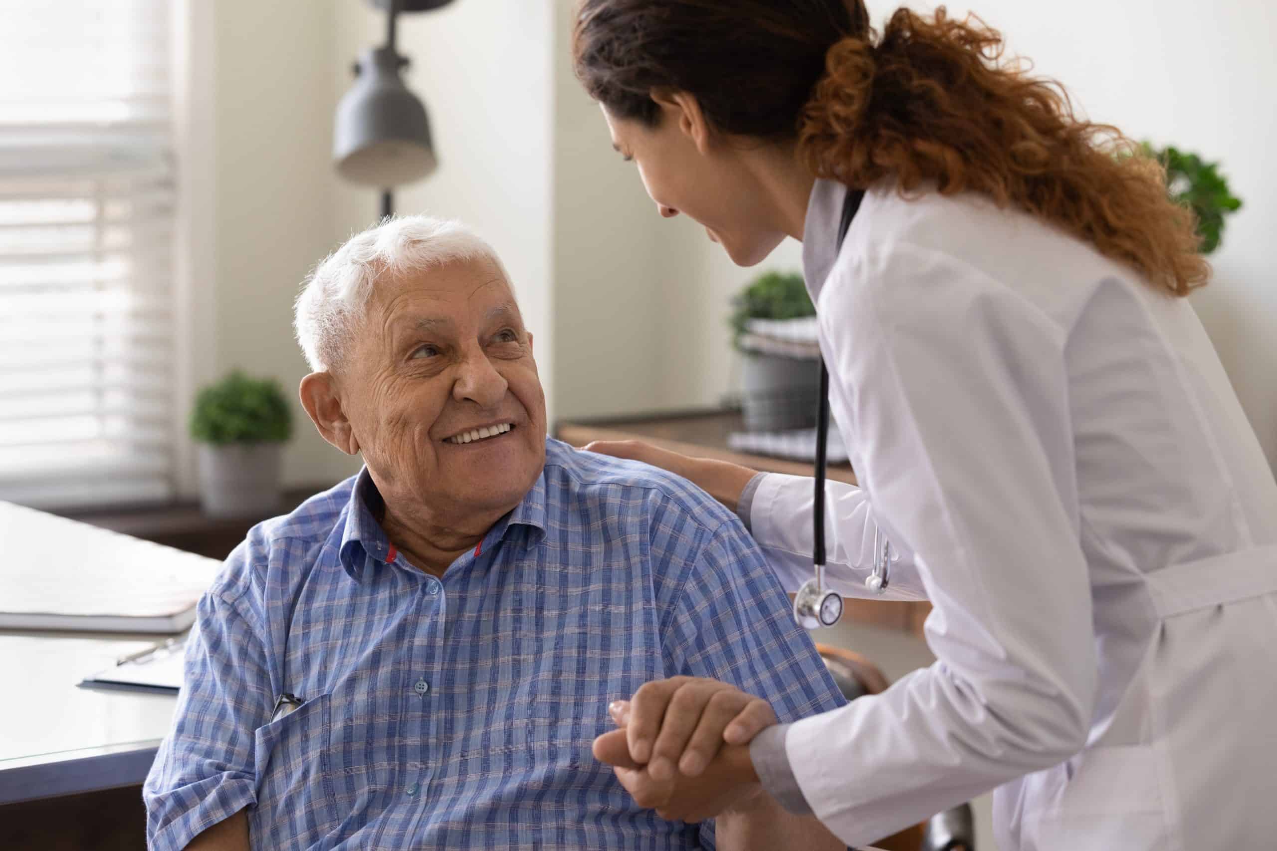 A nurse assisting an older man