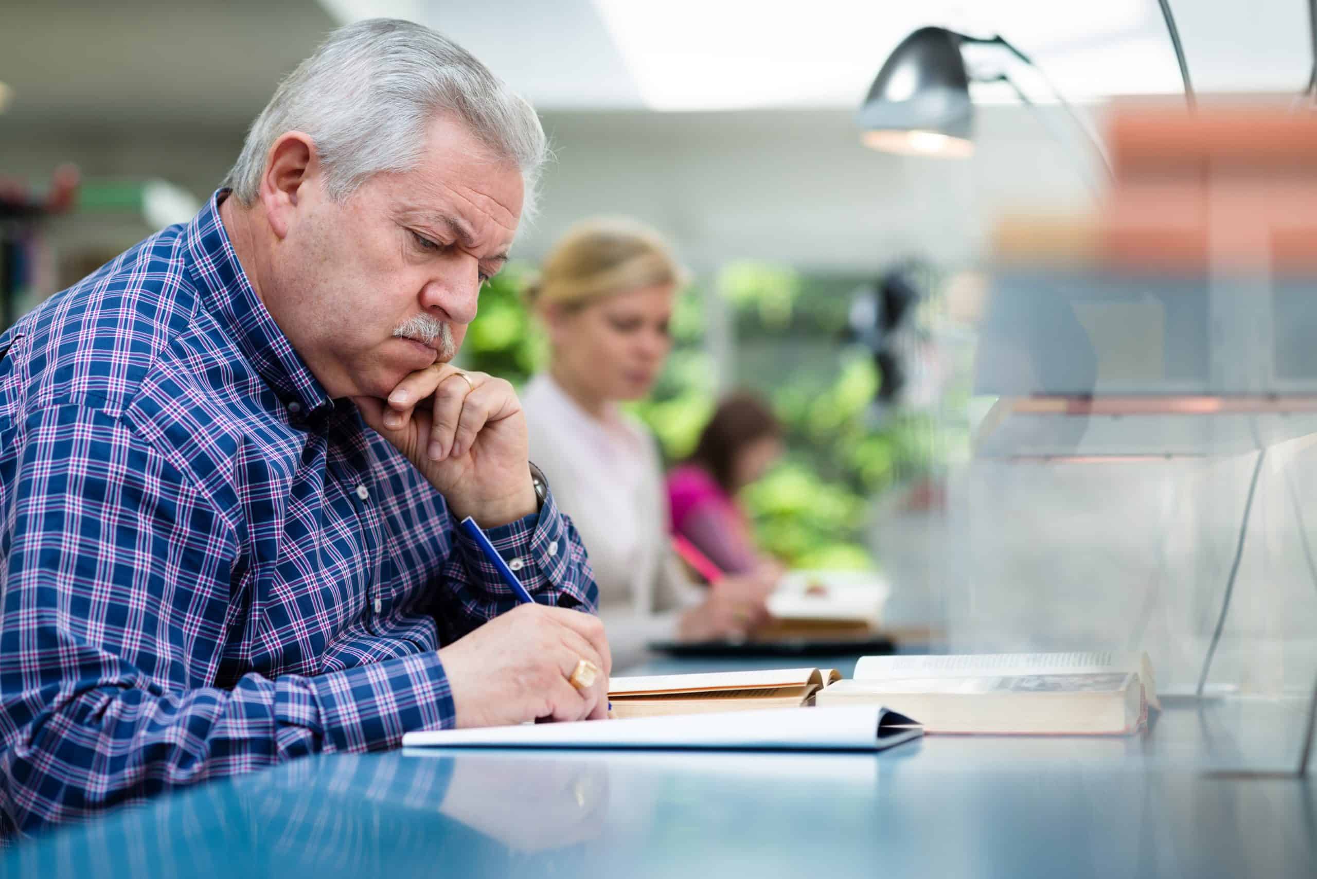 Elderly man studying