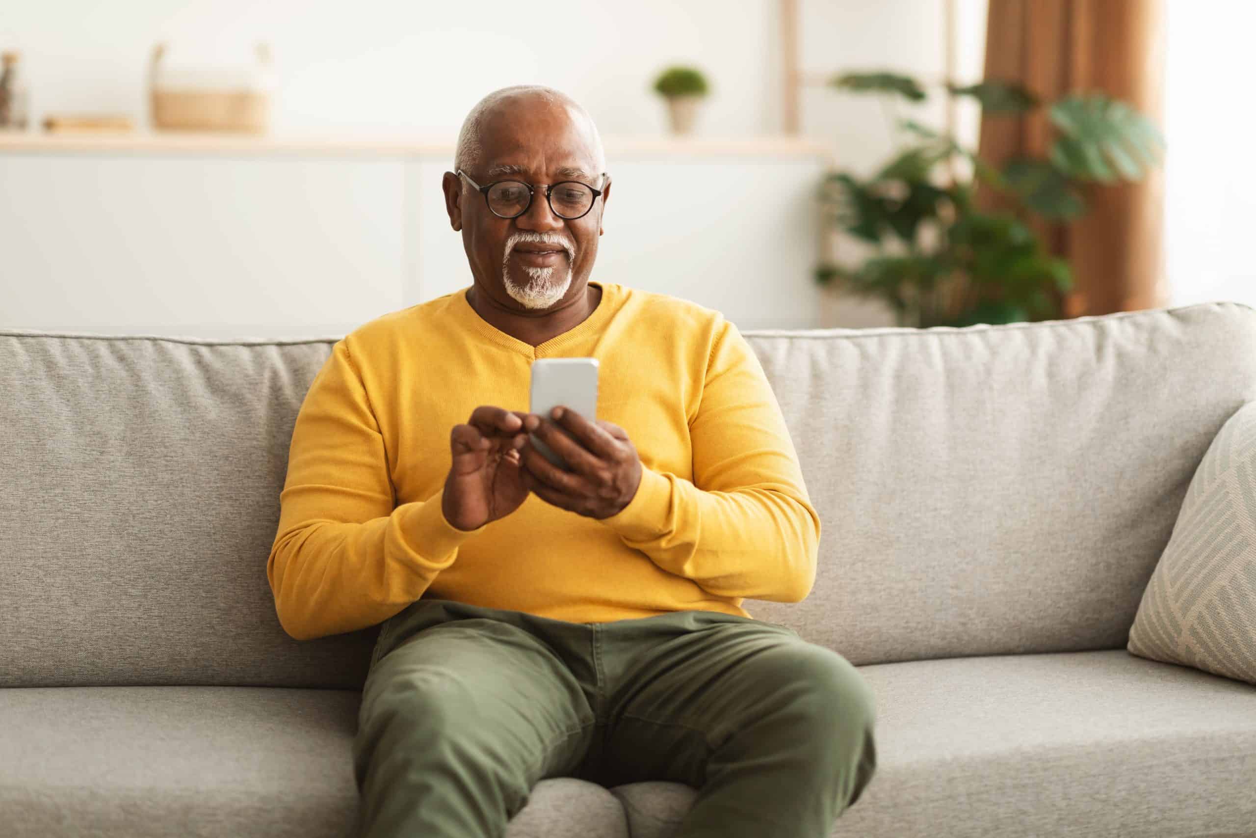 A senior man looking at his phone