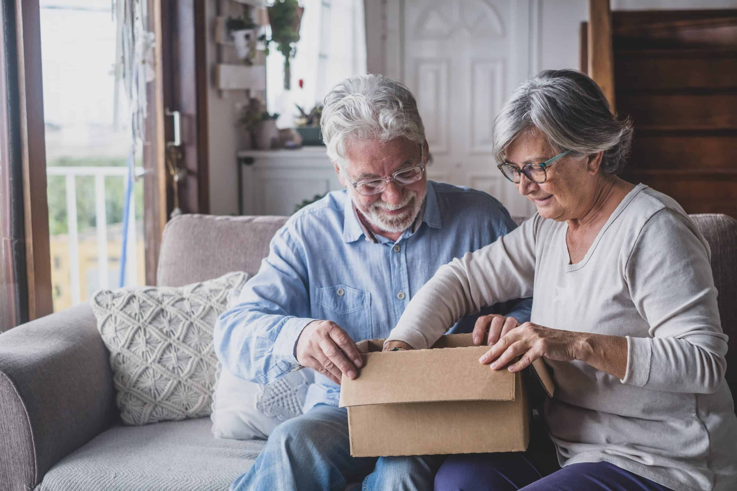 Two adults opening a box