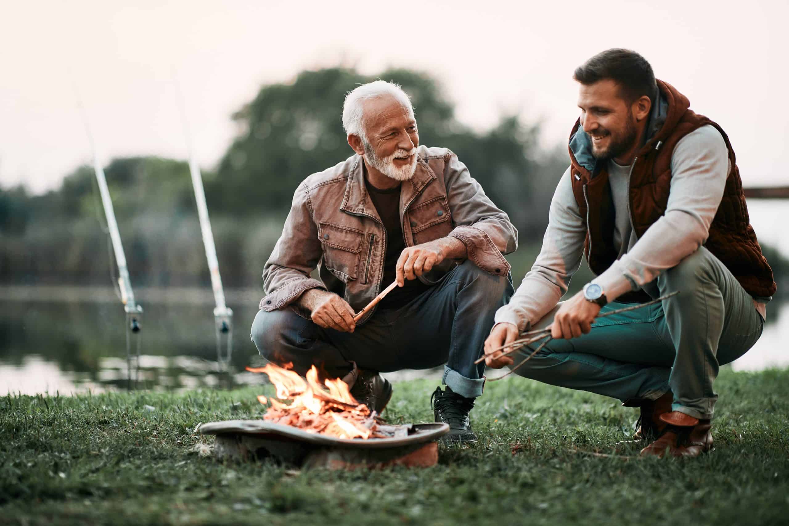 Father and son next to a fire