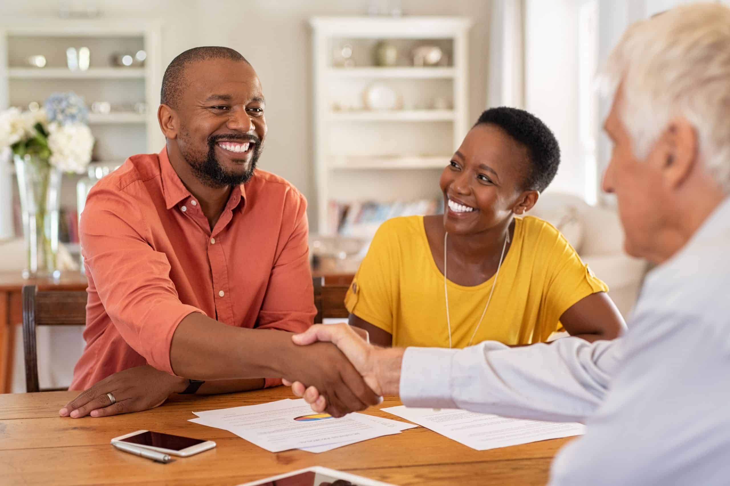 Couple speaking with a financial adviser
