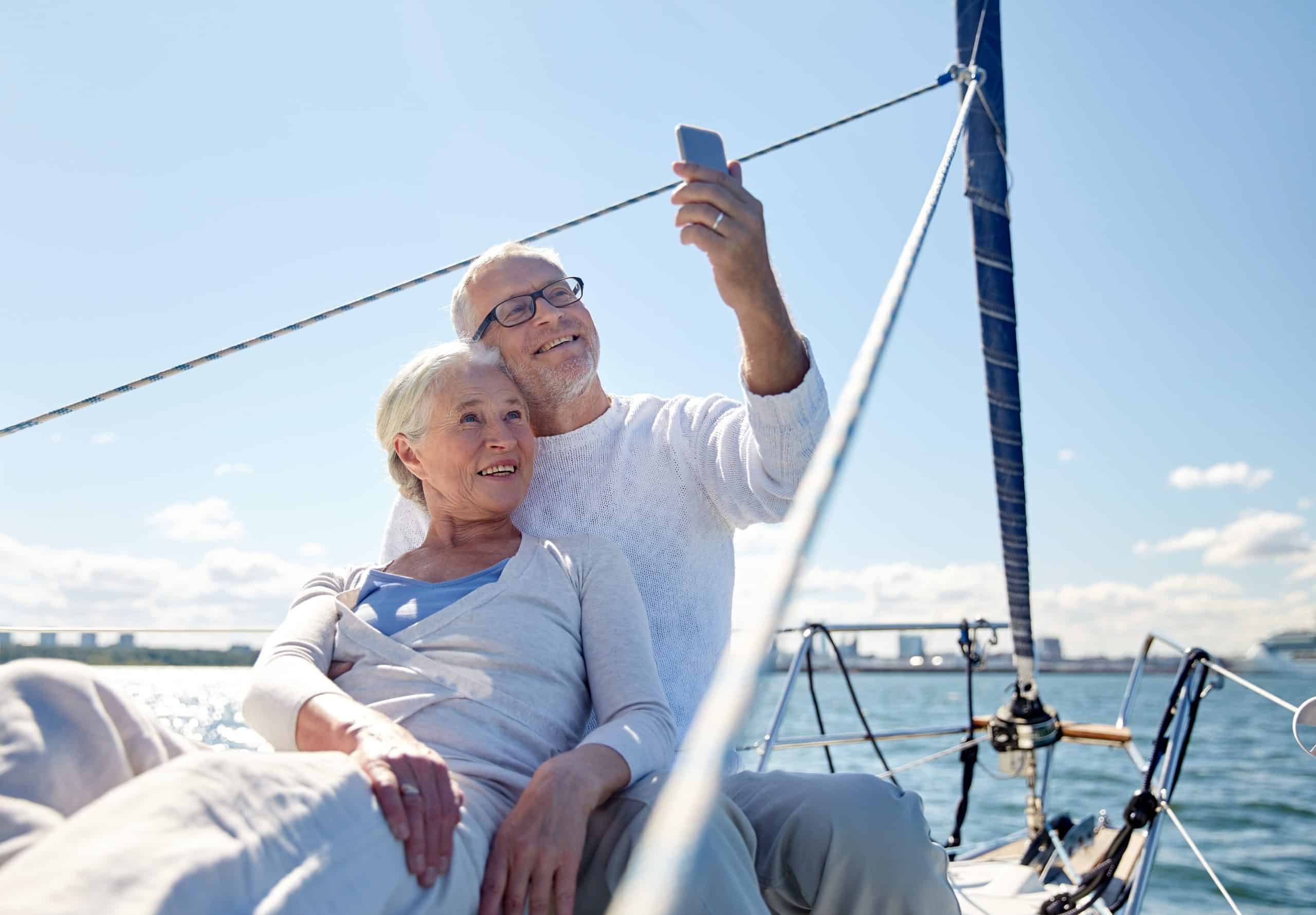 A couple taking a selfei on a sailboat