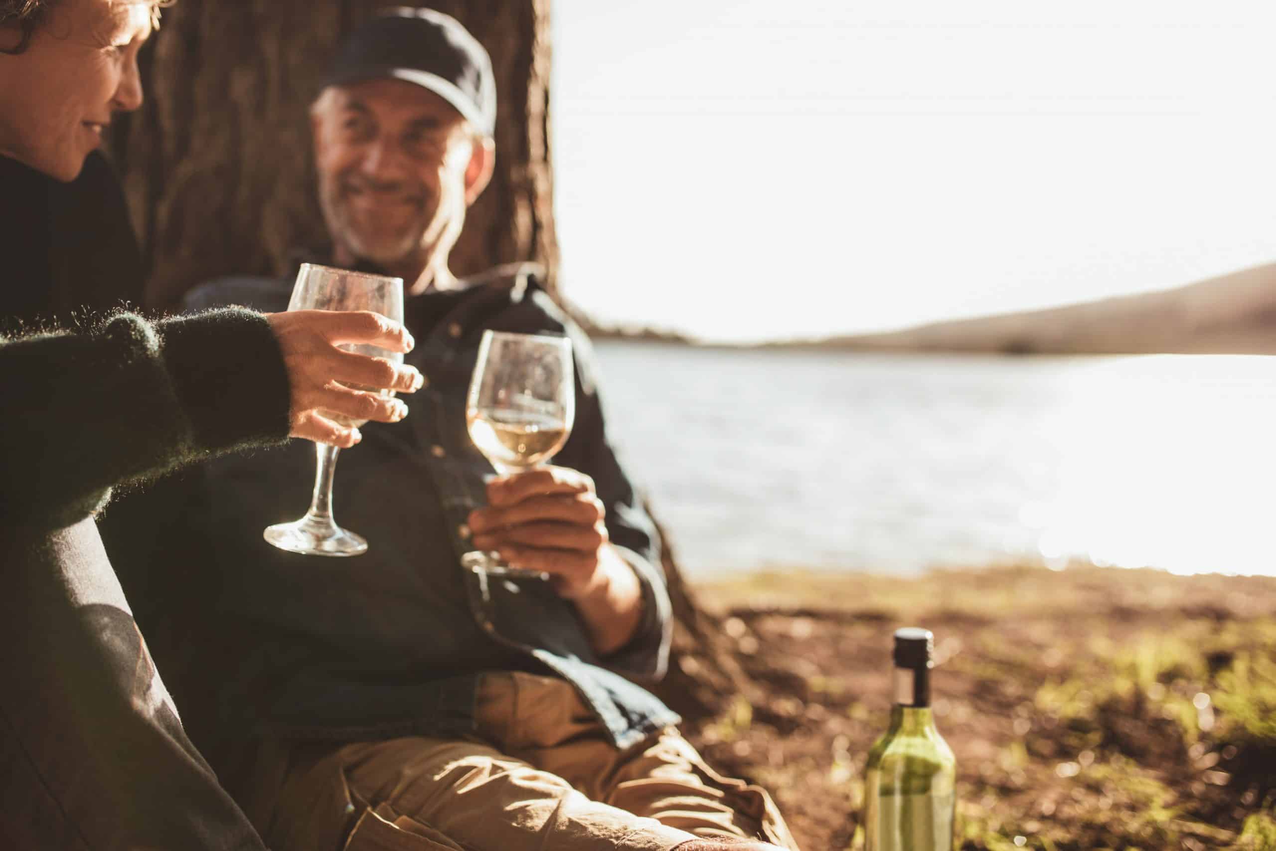 A couple drinking wine outdoors