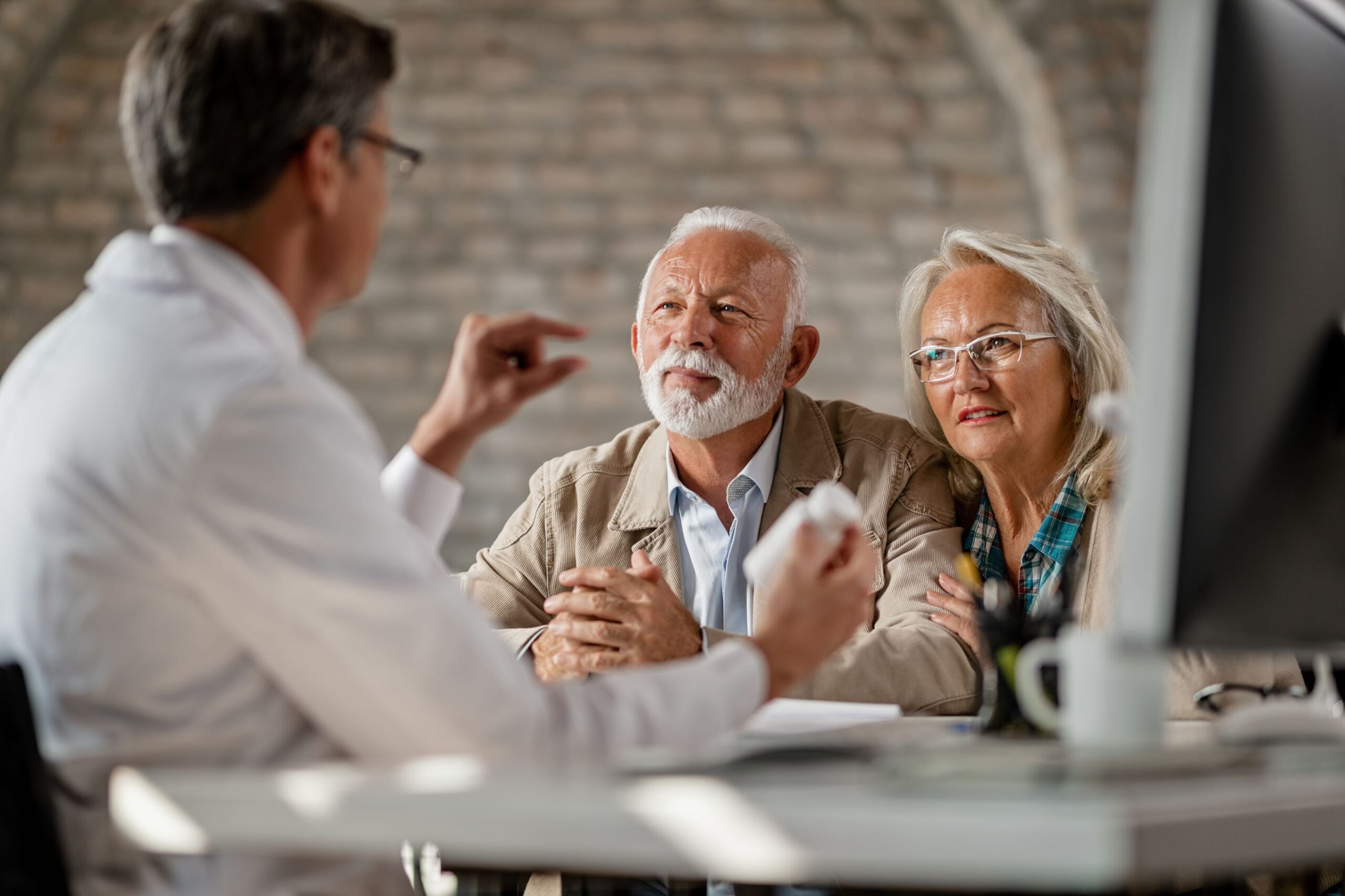 Seniors discussing Medicare with doctor