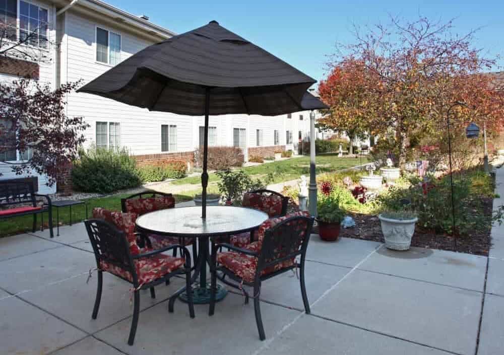 An outdoor dining area and walking path at Bailey Pointe at Miracle Hills.
