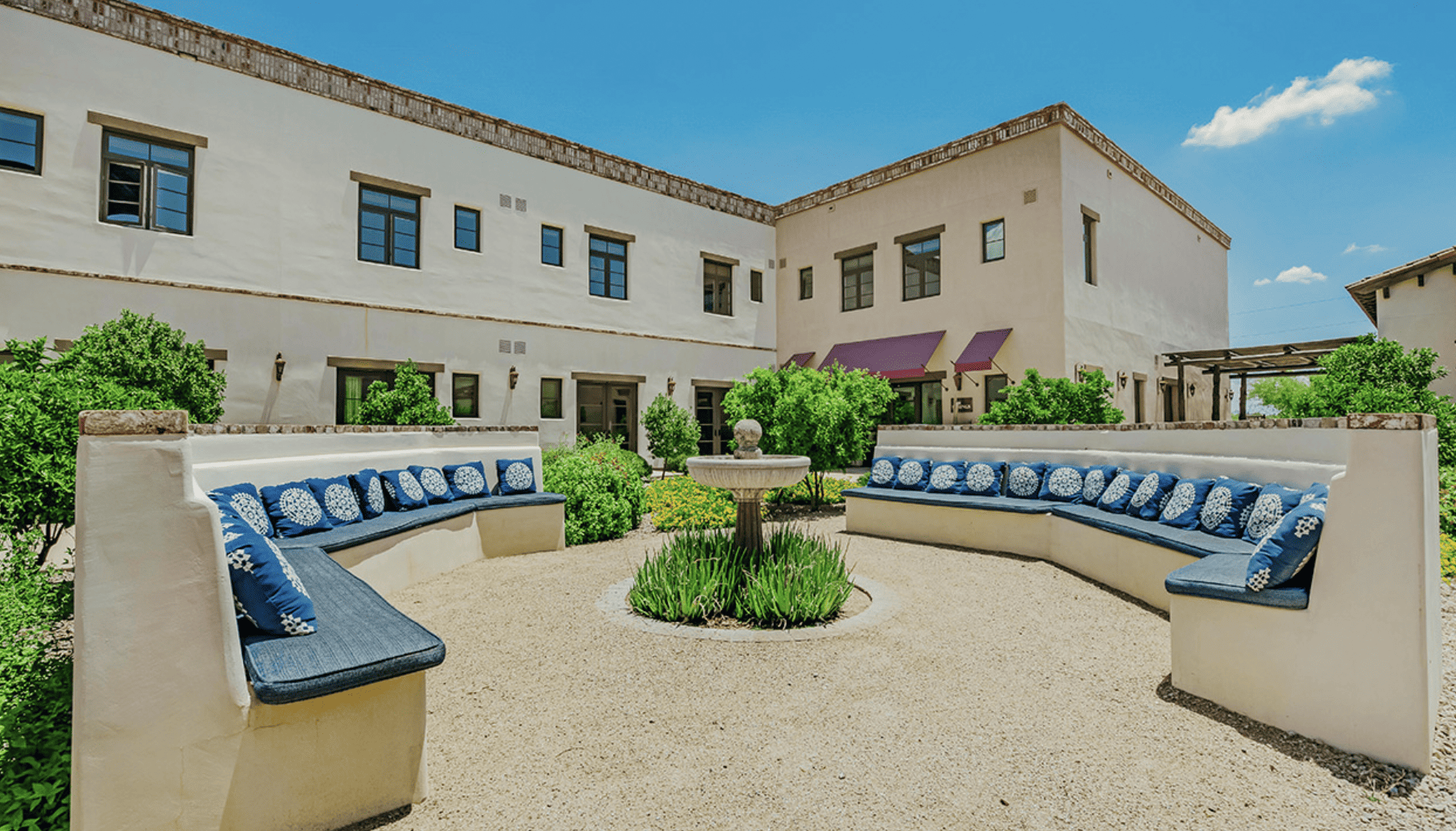An outdoor seating area and courtyard of the Hacienda at the River.