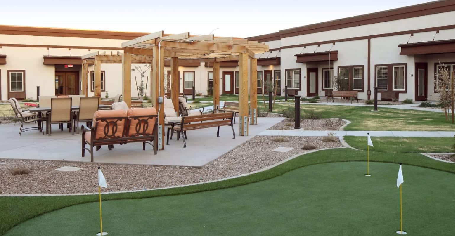 An outdoor sitting area and putting green at Sky Vista Senior Living.