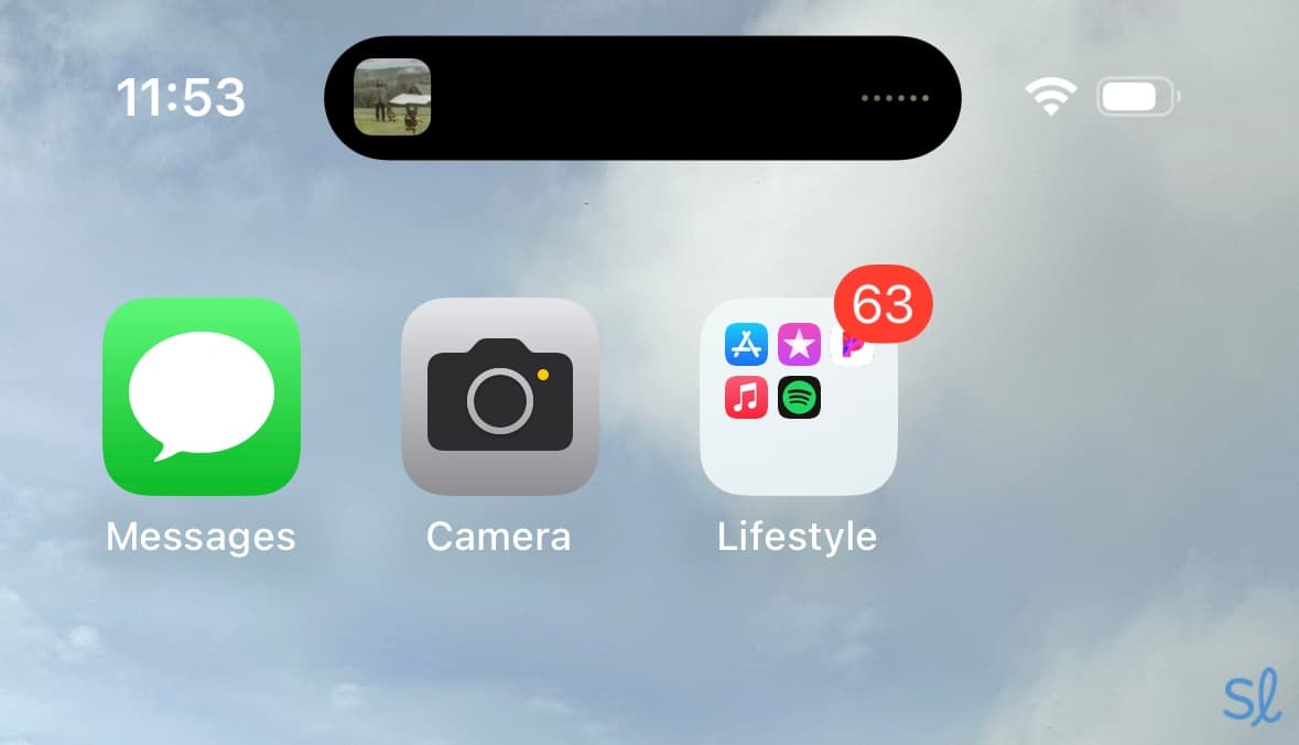 The iPhone's dynamic island can provide quick access to apps like Spotify.